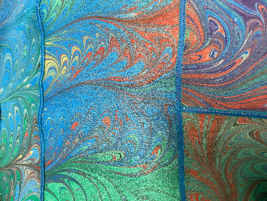 Colorful marbled pattern with swirls of blue, green, and orange.
