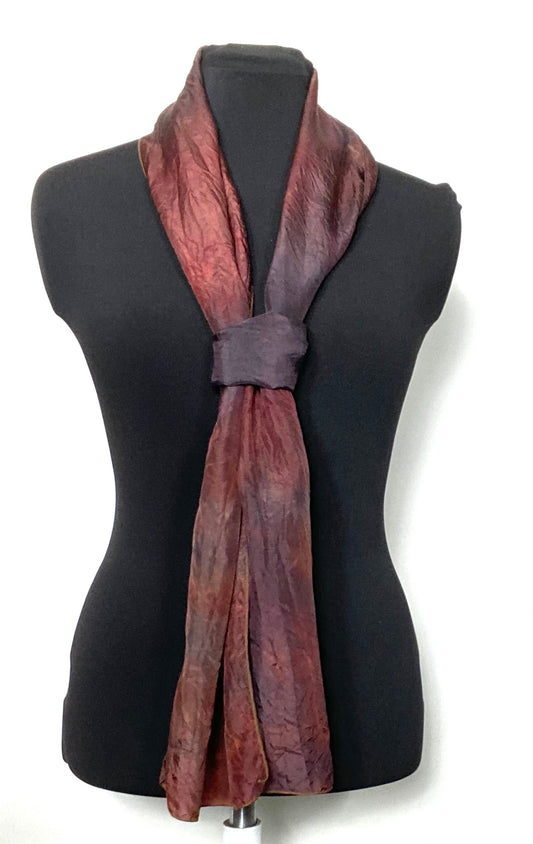 Tied silk scarf in hand dyed mottled tones on a mannequin