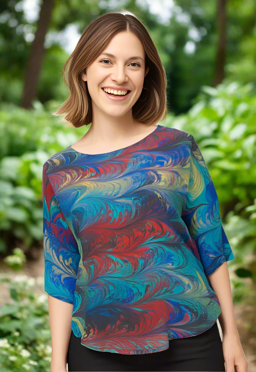 Woman wearing a colorful marbled silk top on a white background