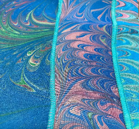 close up of marbled silk scarf with blue, green, and pink swirls