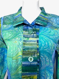 Mannequin wearing a colorful dyed and marbled cotton jacket with blue and green tones.