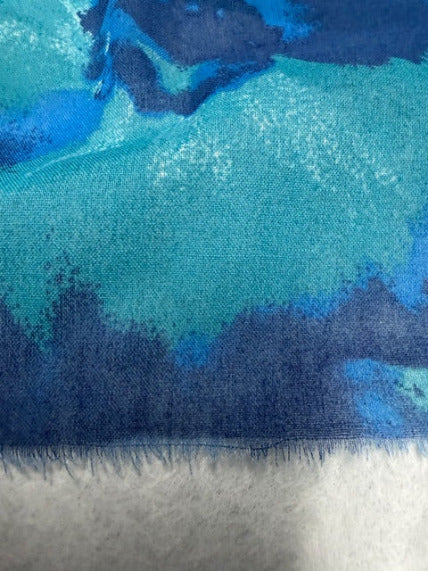 closeup of the fabric and organic fringe end of a cotton scarf