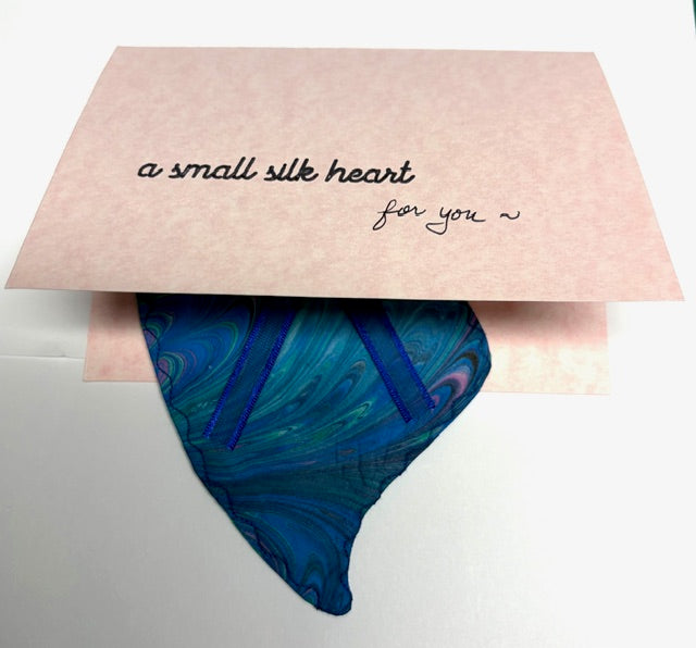 Marbled silk heart shown peeking out of a notecard