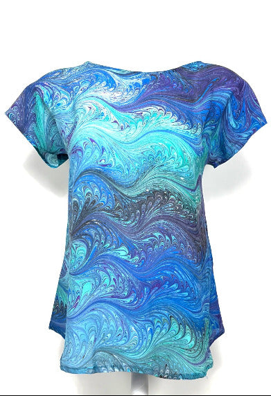 Blue and green marbled patterned silk top on a white background