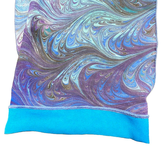 Marbled fabric with blue and purple swirls on a white background