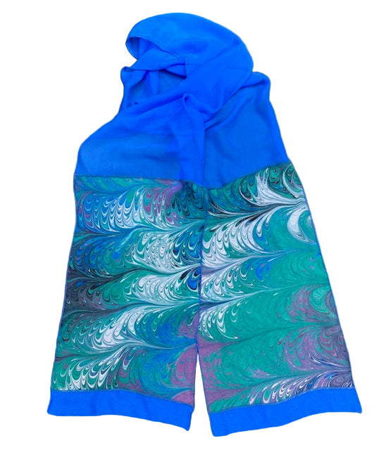 Blue and multicolored marbled silk scarf on a white background