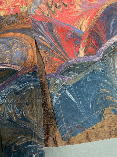 Closeup of side slits on marbled silk vest