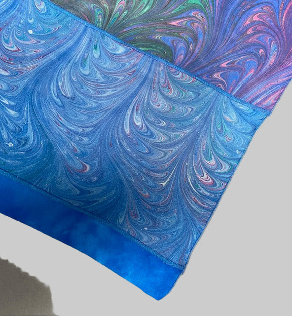 Close up of edge finish of marbled silk scarf