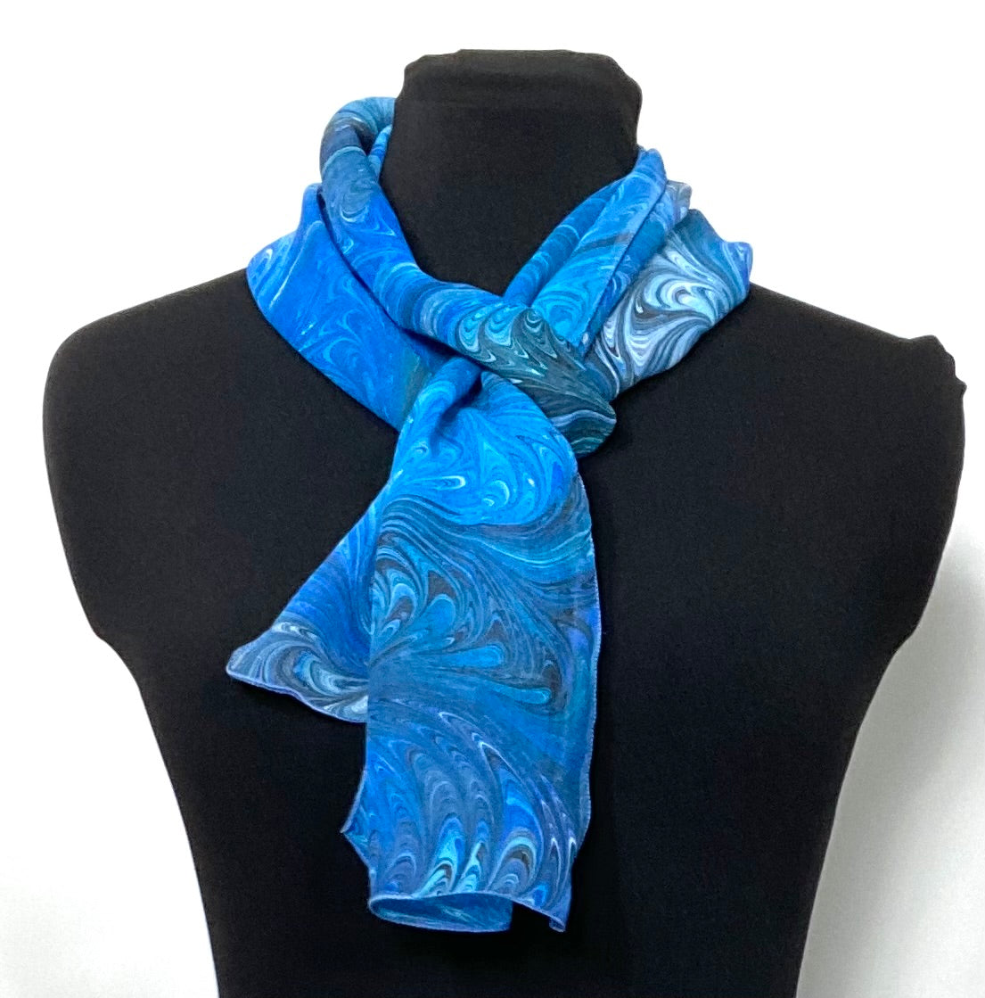 tied marbled silk chiffon scarf in blue, aqua, white and black on a mannequin
