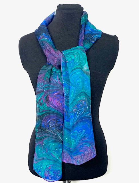 Mannequin wearing a blue and purple marbled scarf on a white background