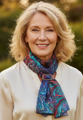 Woman wearing a colorful marbled silk scarf outdoors with a blurred natural background