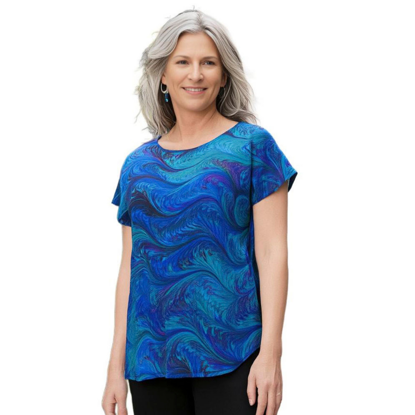 Woman wearing a bright blue and aqua marble short sleeve blouse against a white background
