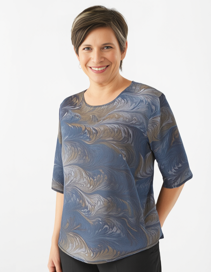 Woman wearing a charcoal and brown marbled silk shirt against a white background