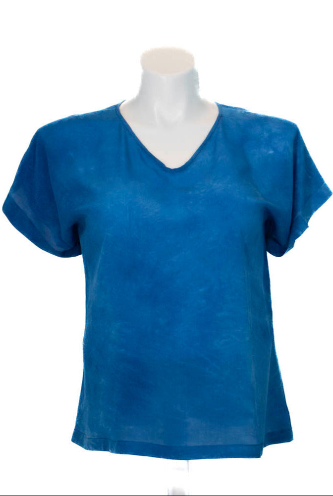 Blue hand dyed silk t-shirt on a mannequin against a white background