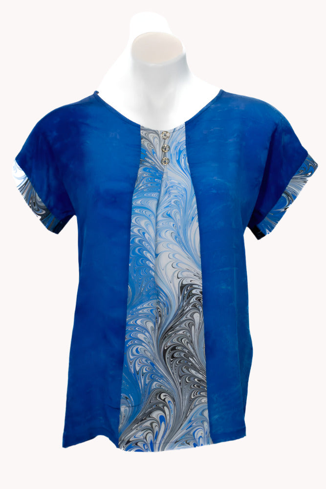 Hand dyed blue blouse with a marbled pattern on a white background