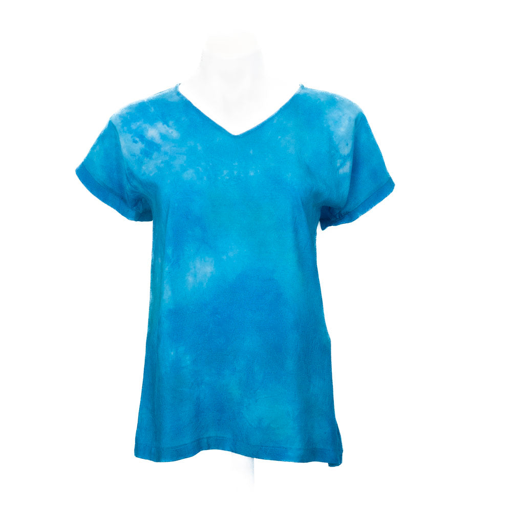 Blue hand, dyed silk T-shirt on mannequin against white background