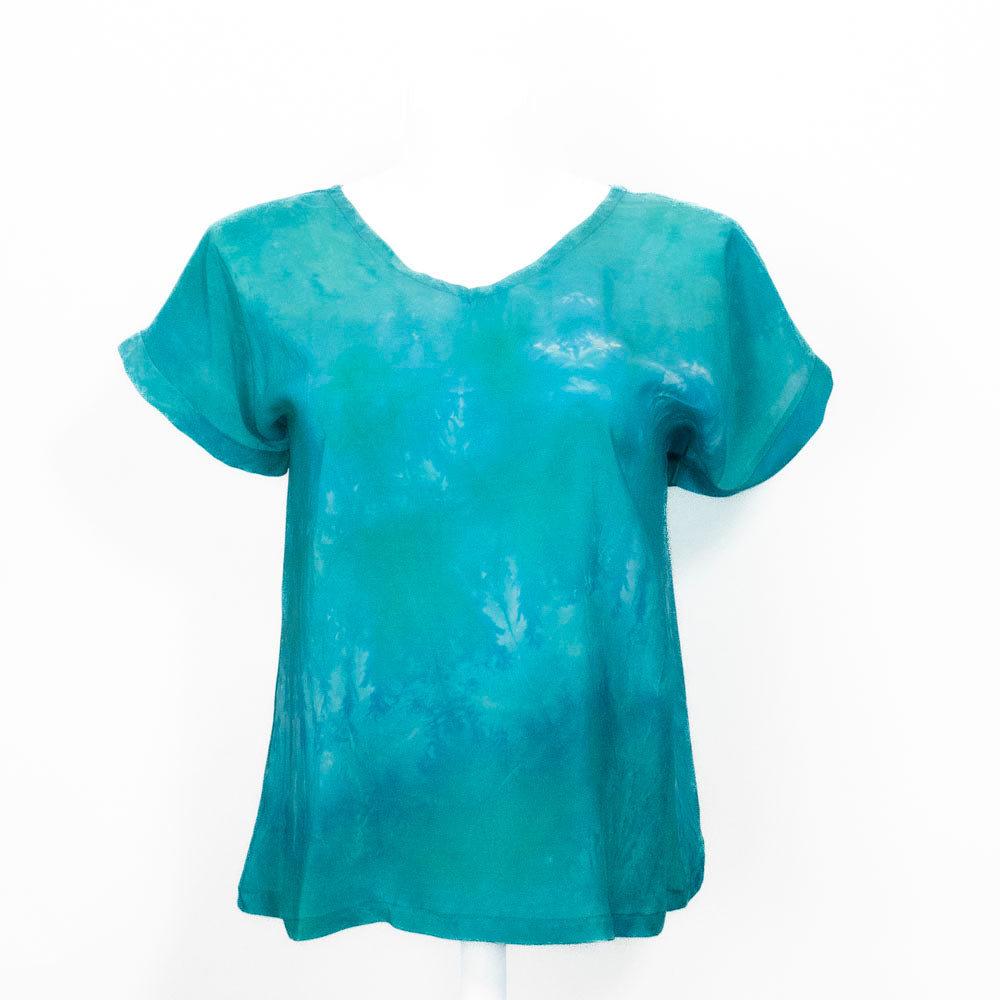 Teal silk tie-dye shirt on a white background