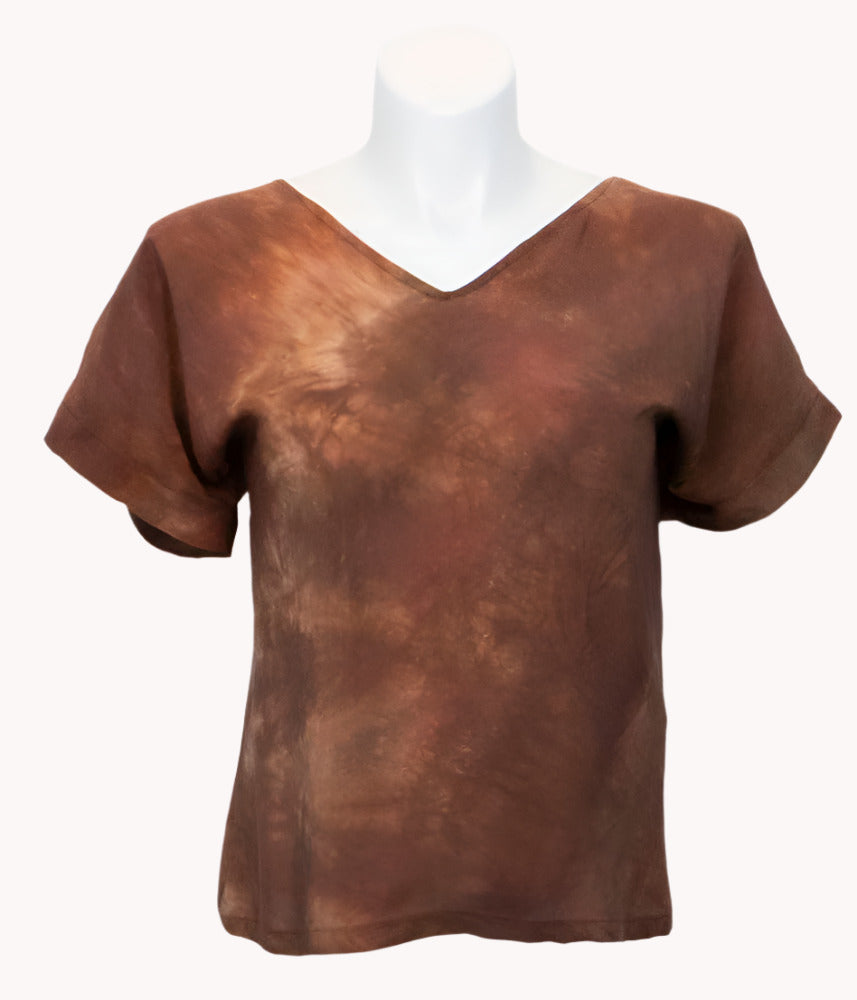 Brown hand dyed silk t shirt on a mannequin against a white background