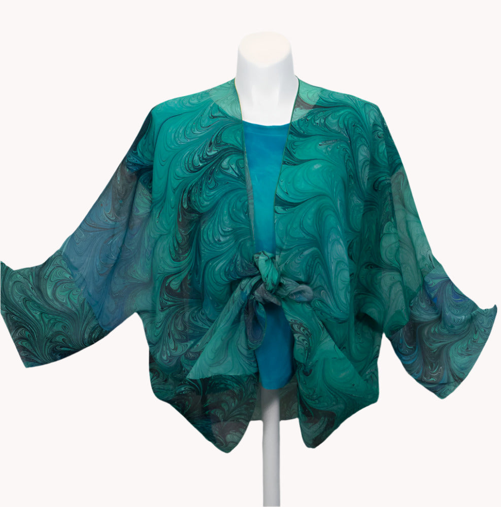 Green marbled sheer wrap/jacket on a mannequin against a white background