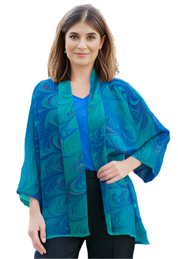 Woman wearing a marbled silk chiffon kimono style jacket and black pants against a white background.