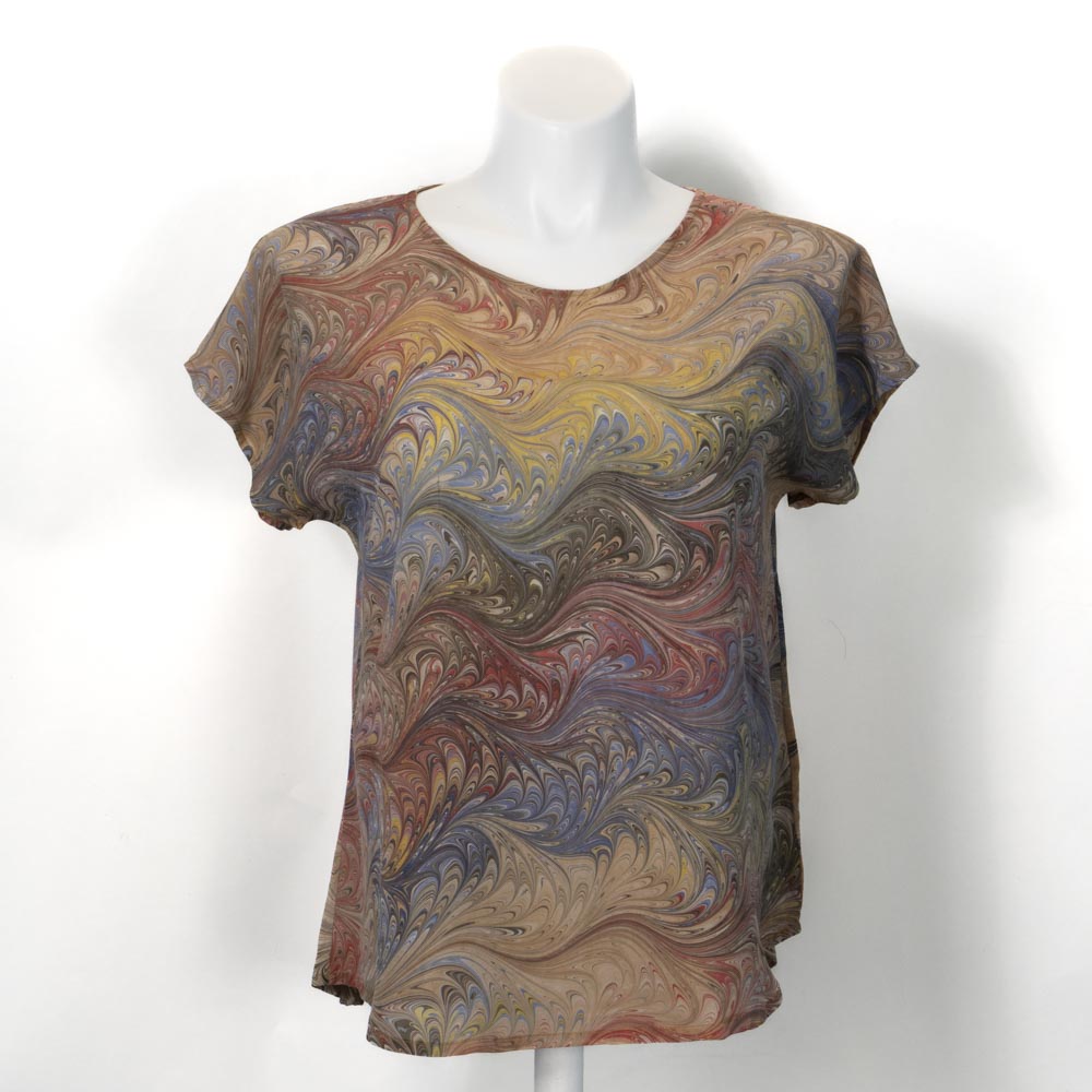Marble silk, short sleeve blouse in gold and browns on a mannequin against a