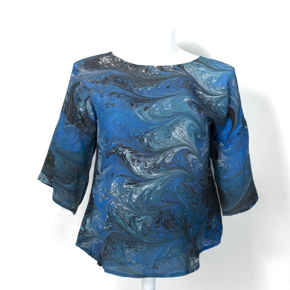 marbled silk blouse in blue, black, aqua and white against a white background