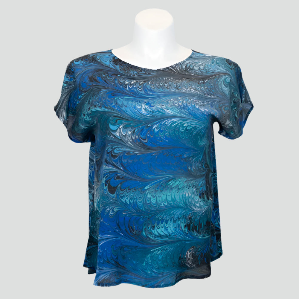 silk blouse with short sleeves marbled in a feathered pattern of blue, aqua, black and white