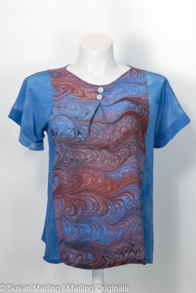 Dyed silk blouse with beautiful marbled, inset piece in pinks, rose and blues on mannequin against white background
