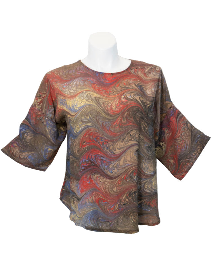 Marbled patterned shirt on a mannequin against a white background