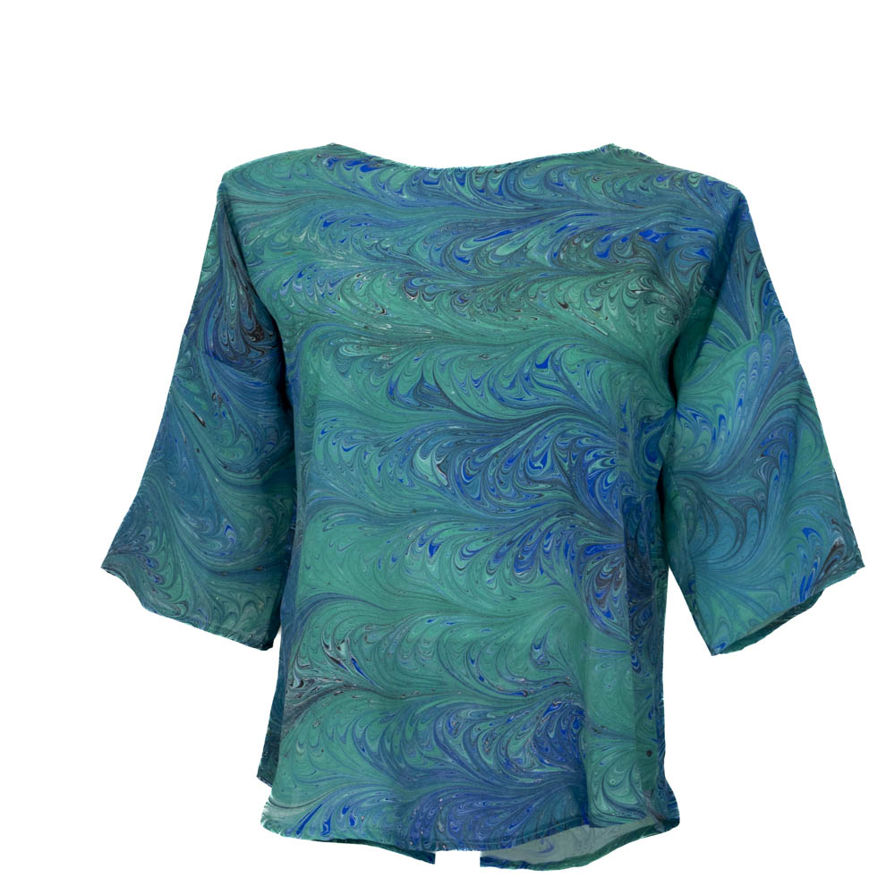 Bright green and blue marbled pattern silk top shown on a mannequin against the white background