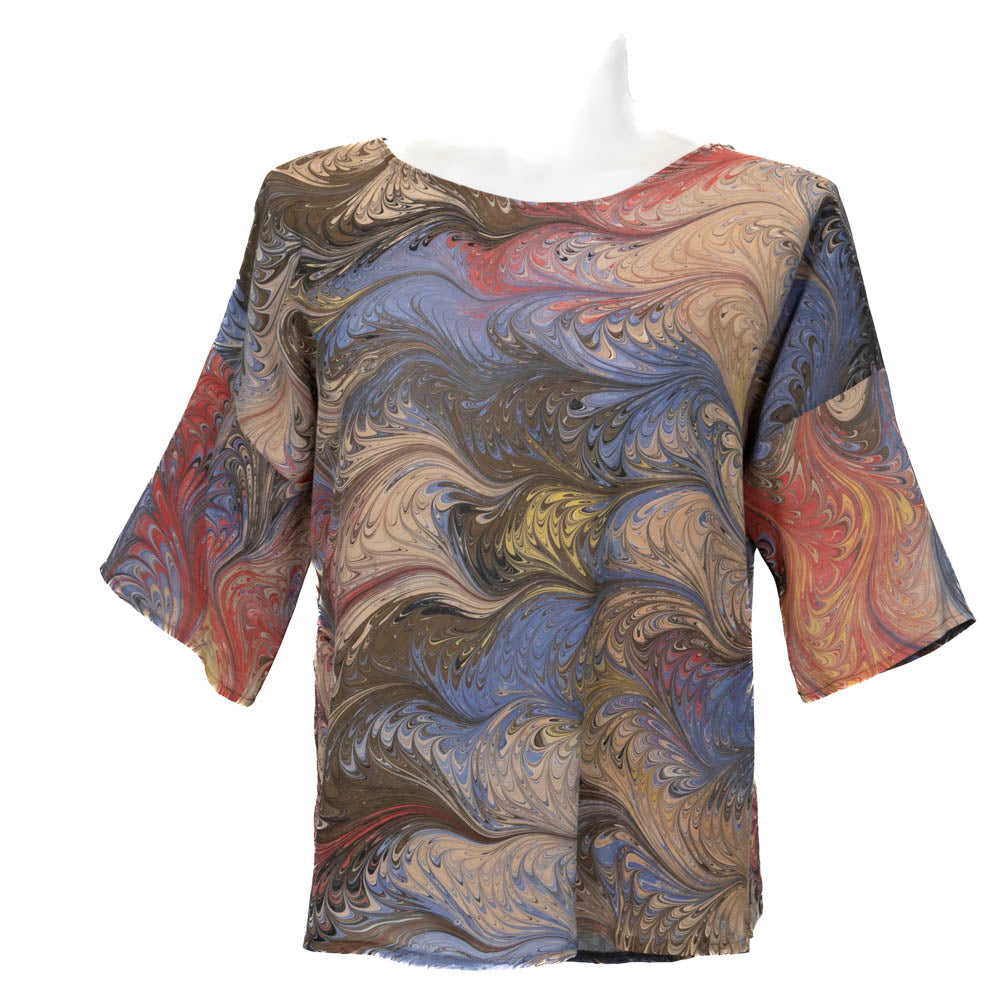 Brown gold and red marbled silk patterned top on a mannequin against a white background