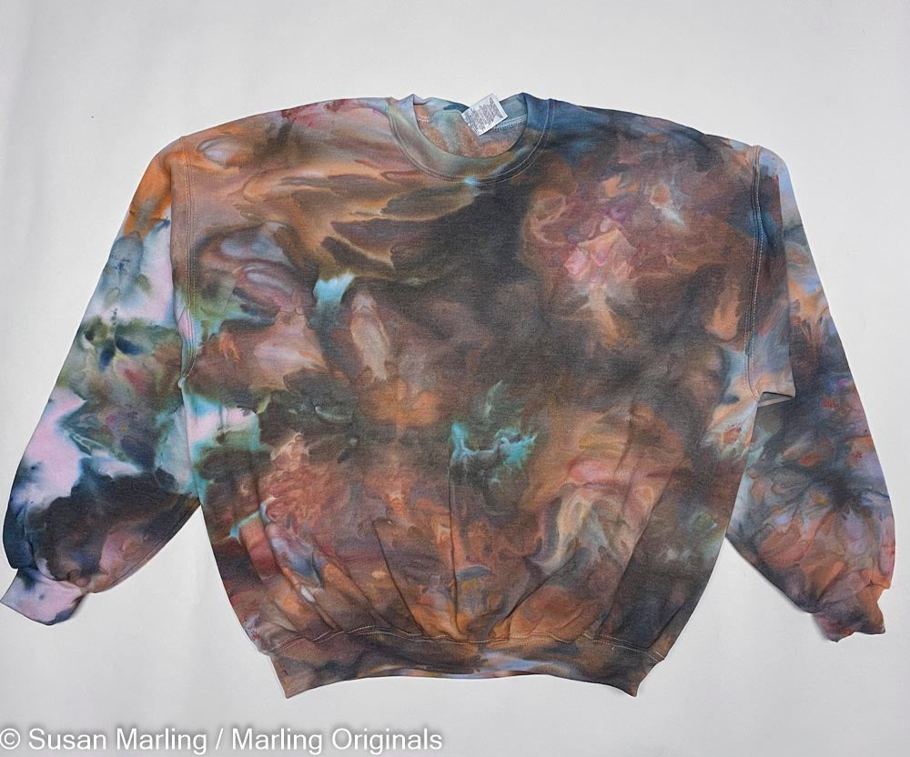 Ice dyed sweatshirt, and brown and purple laying against a white background