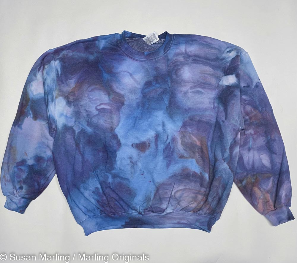 Ice DYED sweatshirt laying against a white background colors are purple and Violet