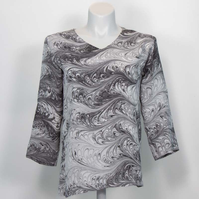 Black and white marbled V-neck tunic with three-quarter sleeves on mannequin against white background