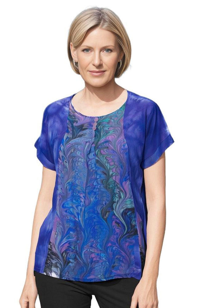 woman wearing hand dyed blue silk top featuring a beautiful marbled center inset