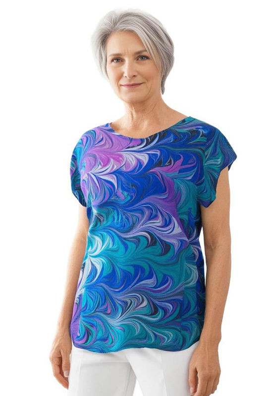 woman wearing a vibrant marbled silk short sleeve top