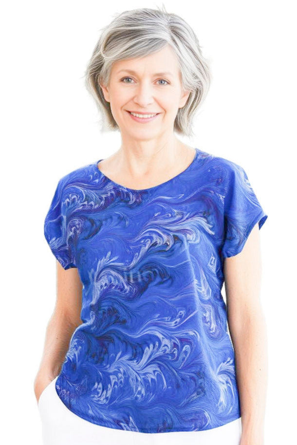 woman wearing soft blue and purple silk top hand marbled