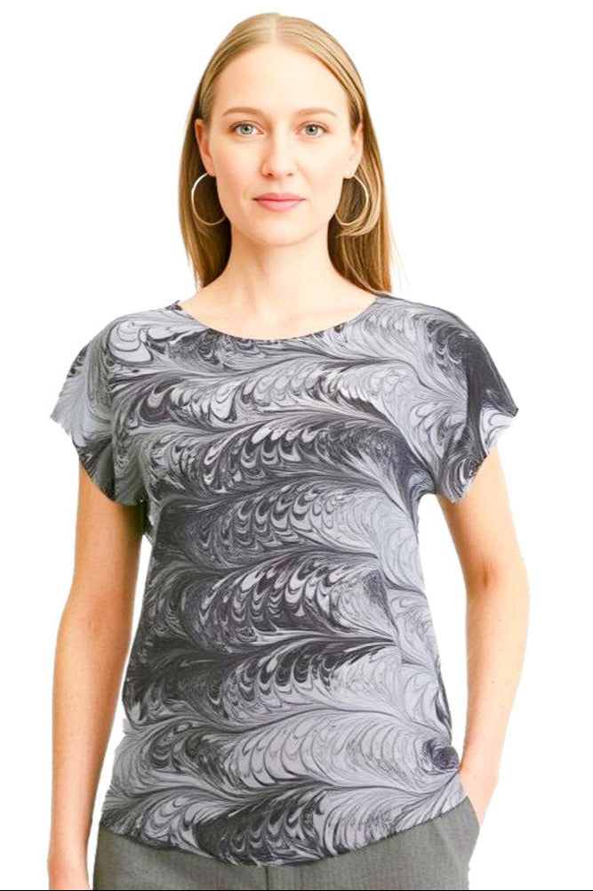 woman wearing a silk top marbled in feathery black and white tones