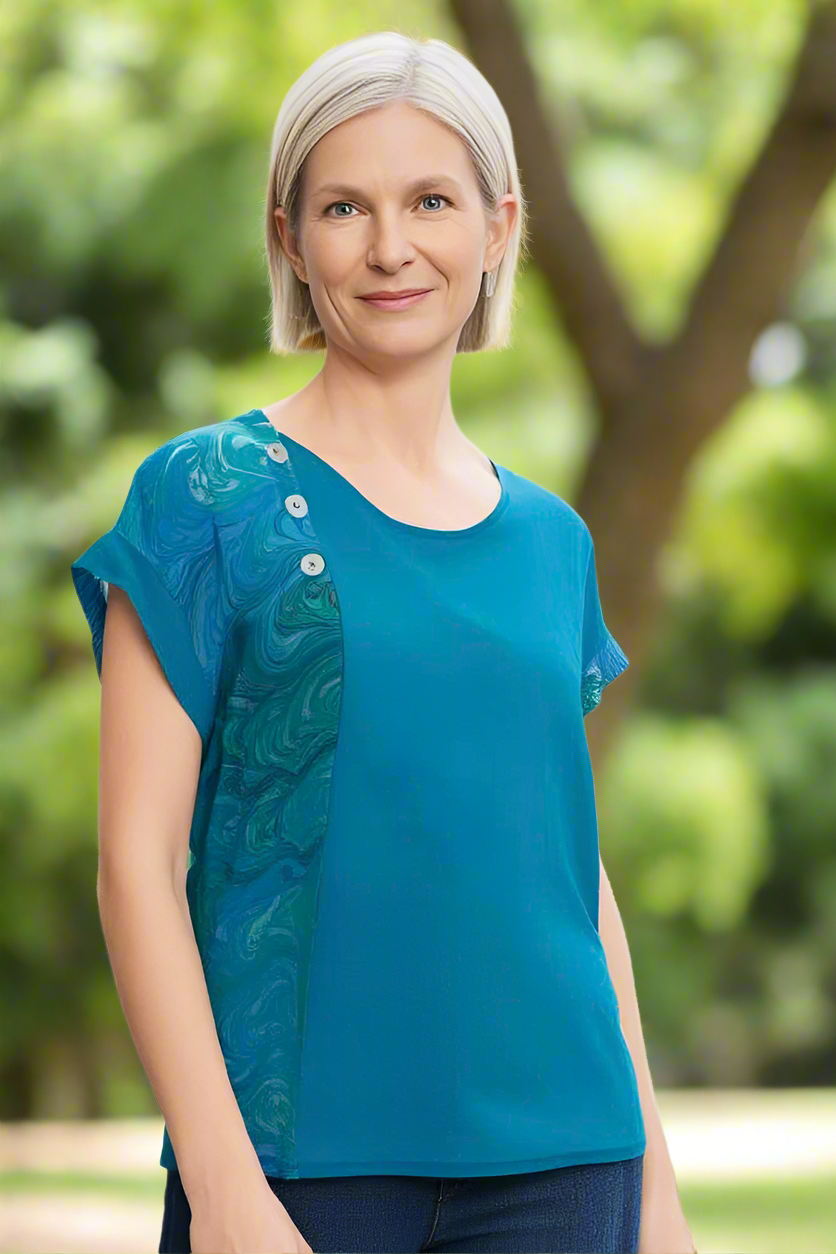 Woman wearing a marbled and dyed silk top in an outdoor setting