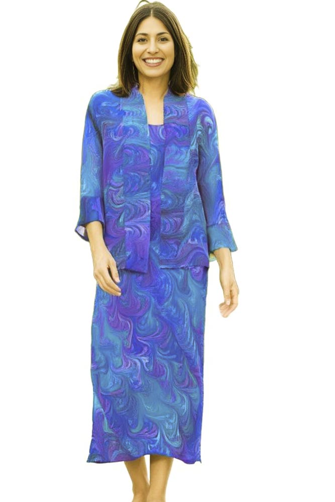 woman wearing long marbled silk dress with matching jacket in blues, purples