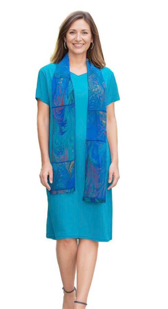 woman wearing silk dress dyed in jade color with marbled silk scarf