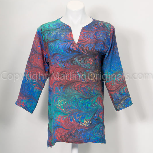 picture of marbled silk tunic in bright primary color.  Notch neck with side slits and 3/4 sleeves