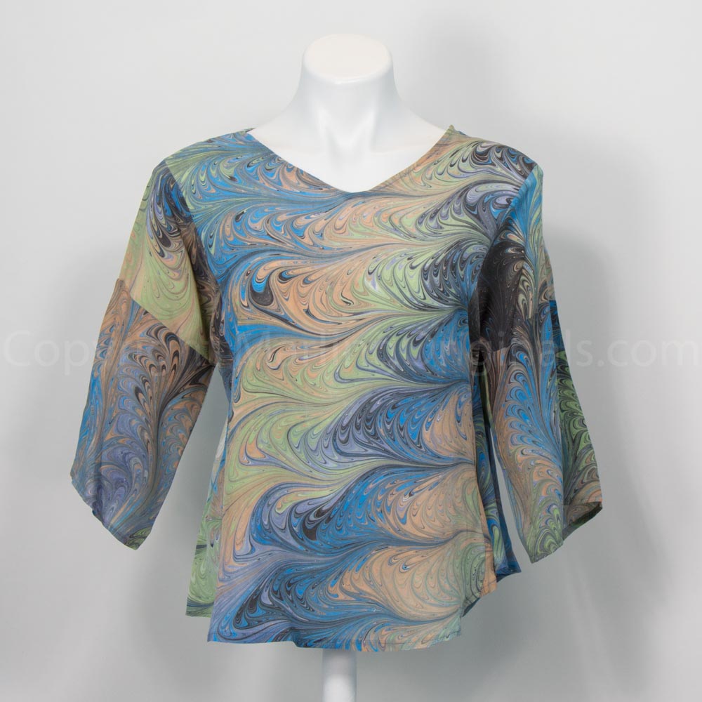 Marbled silk blouse, and gray and blue and tan on mannequin against white background