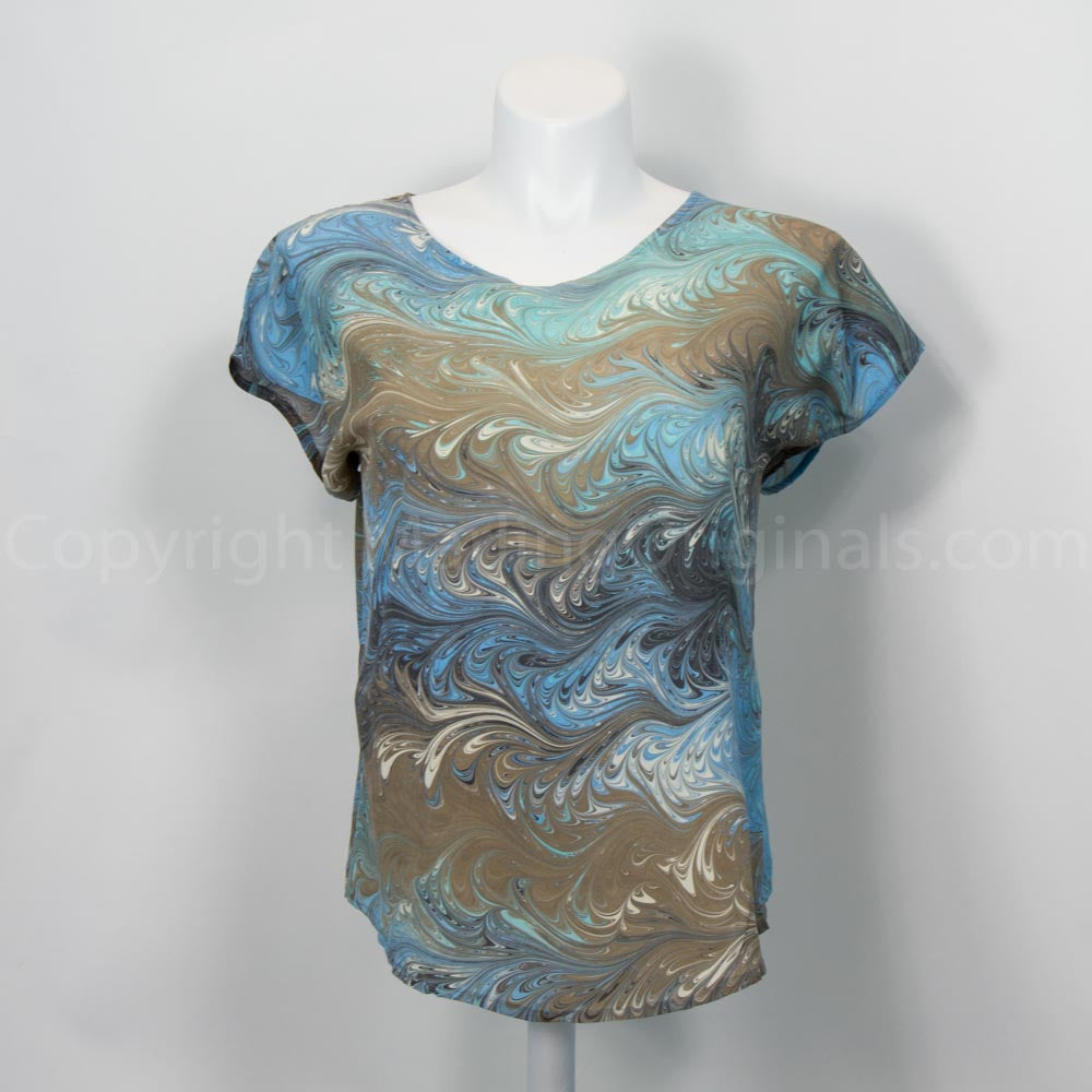 Marbled silk short sleeve blouse in light, aqua, brown, and cream on mannequin against white background
