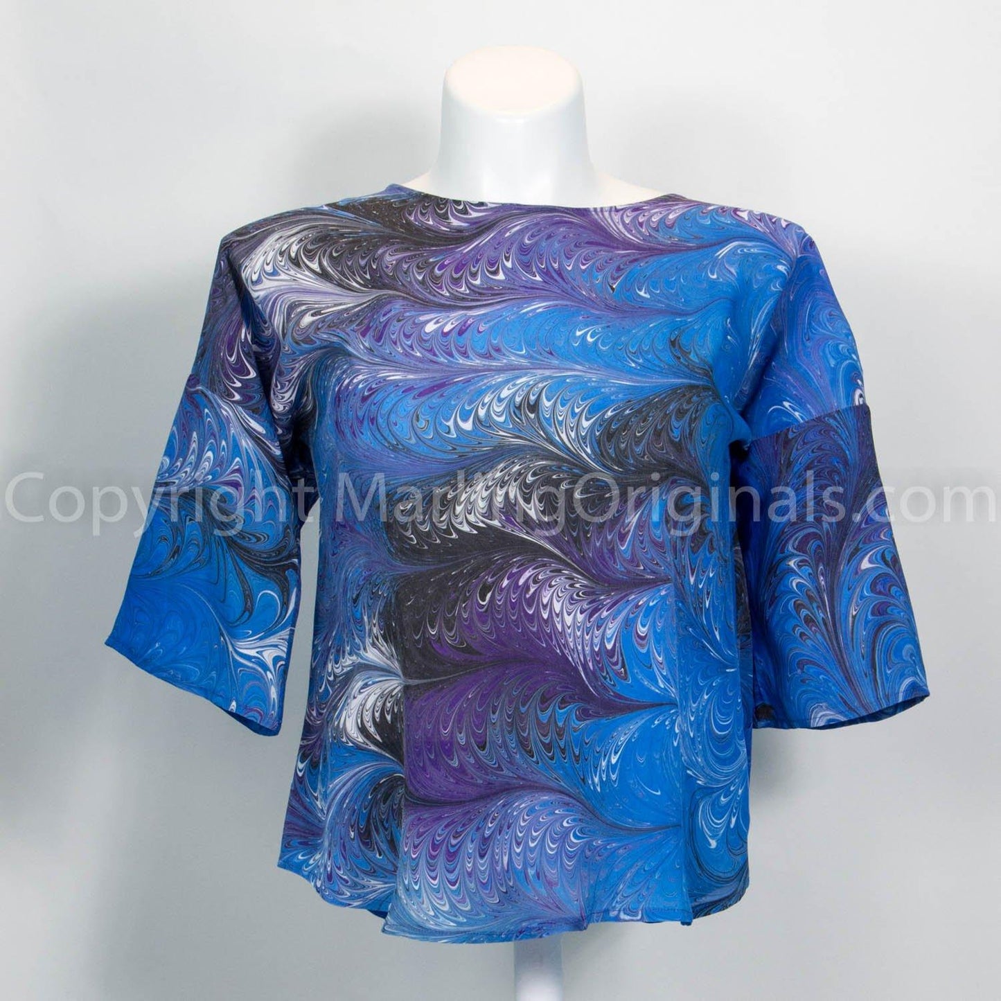 marbled silk top in blue, purple, black and white. Silk top has round neck, hem with half sleeve