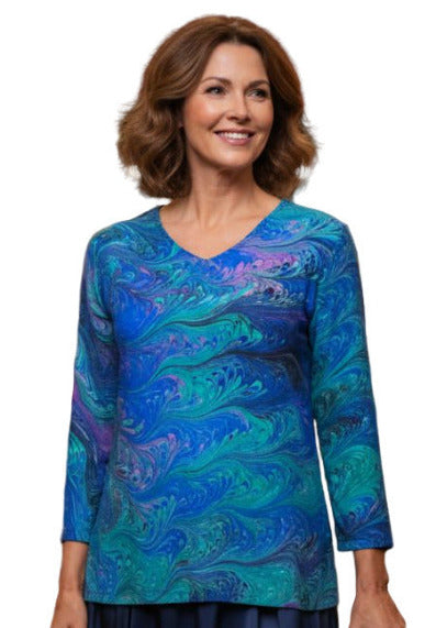 Woman wearing an elegant hand marbled blue green and violet silk tunic 