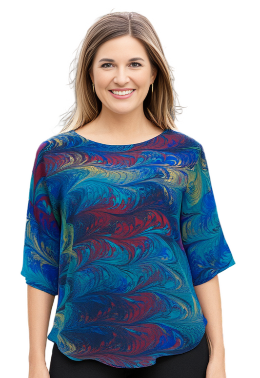 Woman wearing a colorful hand marbled silk blouse on a white background