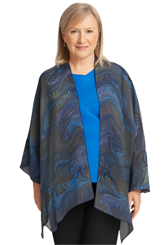 Woman wearing a brown and blue marbled silk wrap/ jacket over a blue top on a white background