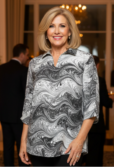 Woman in a marbled silk black and white blouse and black pants