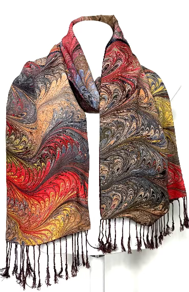 Colorful scarf in marbled silk and a dark brown lining and fringes on a white background